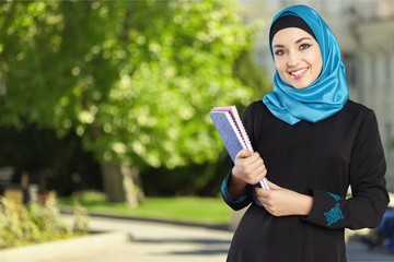 Poster - Happy saudi Arab student holding folders isolated on a white background