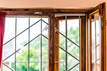Closeup Of Bars In Open Wooden Frame Window During Summer In Dacha Country House For Anti-theft