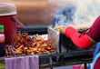 Delicious variety meat grilled with chili sauce on street food stall. Vendor meat roasted to heat on charcoal stove grill have smoke at street food market in Thailand.
