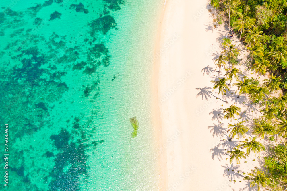 Turquoise lagoon with a coral reef and white beach. Beach with white sand and palm trees, view from above. Puka Shell Beach, Boracay Island, Philippines, aerial view. - obrazy, fototapety, plakaty 