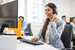 © Bojan - Friendly female customer support operator working in call center. Help and technical support concept.