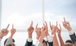 © ASDF - group of young businessmen standing in a circle and pointing up