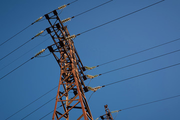 high voltage pole with wires on clear sky background