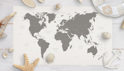 Wall Mural - World map surrounded by shells, starfish, lifebelt, anchor. White wooden table in background. Flat lay, top view.