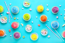 Sweet Tasty Cupcakes With Candies On Color Background