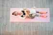 © Loginova - Top view of young mother does fitness exercises together with baby girl.