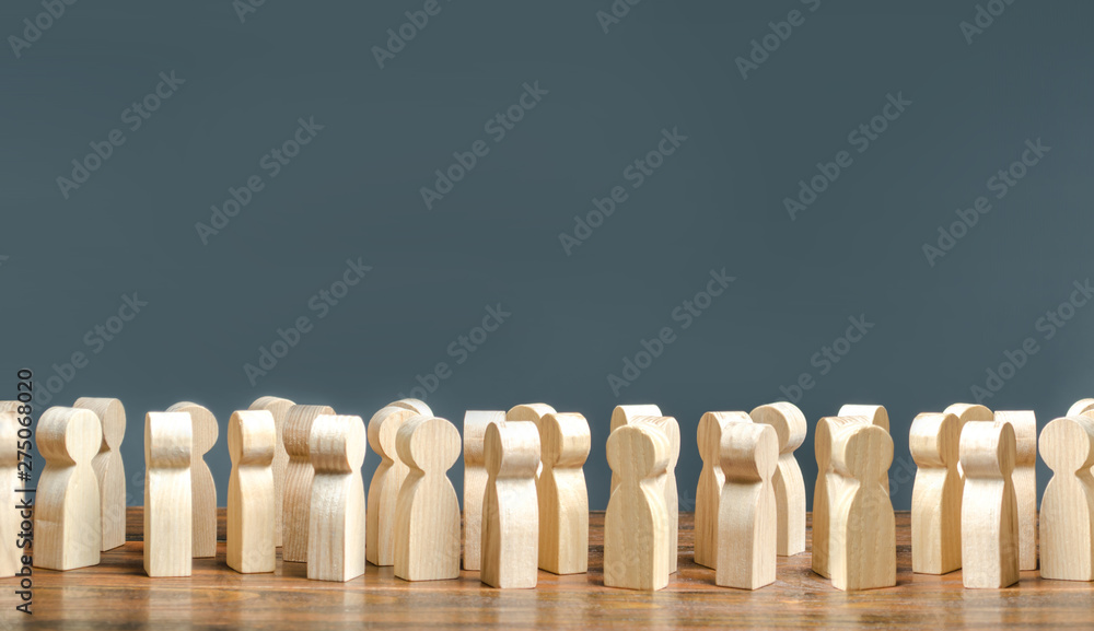 A crowd of wooden figures of people. society, demography. group of citizens, rally, political movement or electorate. Customers and buyers, statistics, preferences of Population. Employees. Copy space - obrazy, fototapety, plakaty 