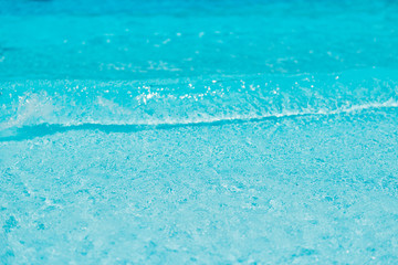 clear blue water waves background closeup at sea coast line