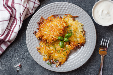 Fried cakes of grated potatoes on the plate with sauce. Traditional pancakes boxty raggmunk