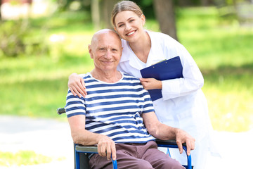 Poster - Elderly man with caregiver in park