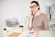 © Anton - Mid age businesswoman talking on the phone in the office