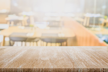 Wall Mural - Blank Wood Table Top on Blurred Restaurant furniture Tables Chairs Stools or coffee cafe background for montage product present on counter table