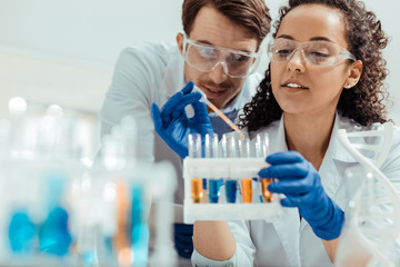 Wall Mural - nice positive woman holding a test tube rack