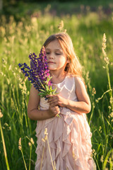 girl and  lupine flower in nature