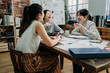 © PR Image Factory - three asian woman coworkers laughing at funny joke while meeting in office. girls colleagues in friendly work team enjoying positive emotions and discussing project together. group of happy partners