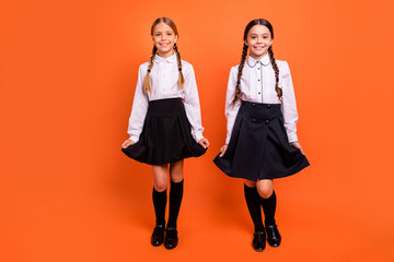 Canvas Print - Full length body size view of two person nice-looking attractive charming cute lovely sweet winsome cheerful cheery pre-teen girls isolated over bright vivid shine orange background