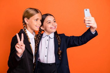 Sticker - Close up side profile photo beautiful she her little sisters lady hand arm v-sign symbol telephone make take selfies wear formalwear shirt blazer school form bag isolated bright orange background