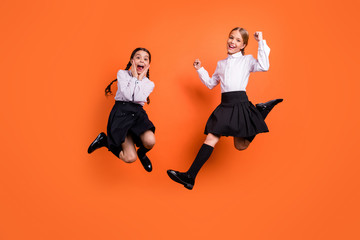 Poster - Full length body size view of two person nice attractive charming cheerful cheery pre-teen girls having fun new academic year September a-mark isolated on bright vivid shine orange background