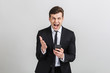 © Drobot Dean - Image of angry yong businessman in formal suit typing on cellphone and screaming at camera