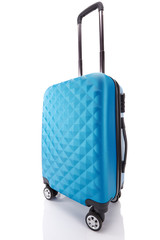 blue textured wheeled travel bag with handle isolated on white