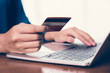 © KanyaphatStudio - Happy Asian woman shopping online and paying by credit card.technology and ecommerce concept