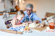 © Marina April - Grandmother is teaching child to cook pastries and apple pie in cozy home kitchen. Senior woman and little girl are happy together. Cute kid is helping to prepare dough. Lifestyle authentic moments.