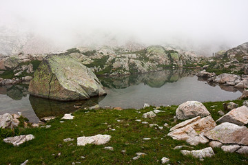 Wall Mural - fog near lake claus, on the maritime alps, in italy.