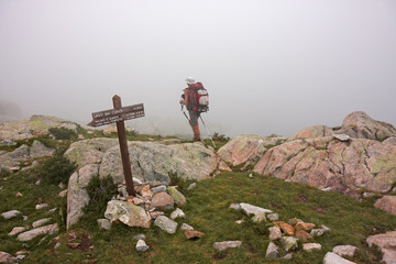 Wall Mural - a hiker walk along an old mule track near lake claus, in italy.