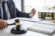 © Freedomz - Judge gavel with Justice lawyers, Businessman in suit or lawyer working on a documents in courtroom. Legal law, advice and justice concept