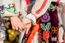 Close Up Of Hands Of Young Romanian Dancers Perform A Folk Dance In Traditional Folkloric Costume. Folklore Of Romania
