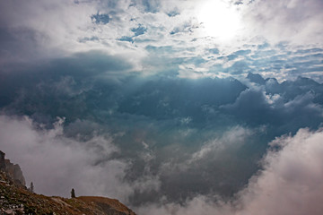 Wall Mural - panoramic view of the mountain peaks shrouded in the mists of dawn.