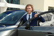 © New Africa - Attractive young man near luxury car outdoors