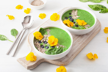 Wall Mural - green spinach smoothie bowl with blueberry, chia seed and edible pansy flowers