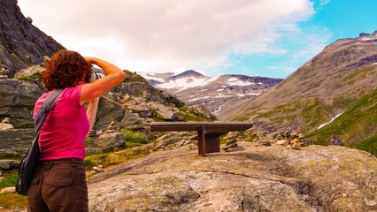 Wall Mural - Tourist with camera on Trollstigen viewpoint