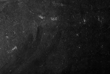 white dust and scratches on a black background. The texture of dirt on the glass.