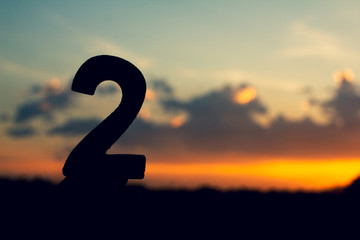 Wall Mural - number two sign symbol of wooden 2 text on evening nature sunset ,beautiful cloud