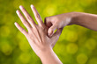 female hands make acupressure on the arm over beautiful green background