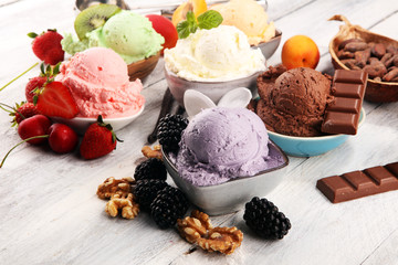 Sticker - ice cream scoops of different colors and flavours with berries, nuts and fruits decoration on white background