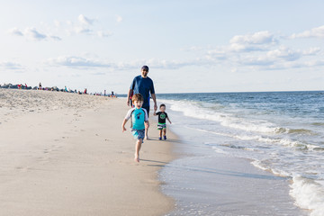 Family Walking On The Beach, Father and Children at the Beach