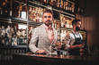 © Fxquadro - Handsome modern man in checkered suit is consuming alcohol at trendy bar.