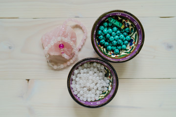 Wall Mural - High angle view on crystal perls stones on wooden table