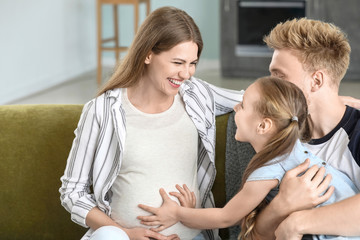 Canvas Print - Beautiful pregnant woman with her family at home