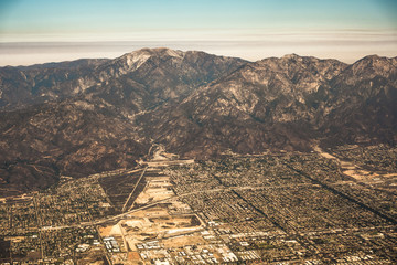 Canvas Print - downtown los angeles skyline and suburbs from airplane and smoke from wild fires