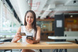 © I Believe I Can Fly - beautiful woman holding credit card reader machine for payment by NFC technology on shopping website online, shopping concept