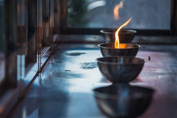 Wall Mural - Candle flame on the lantern in Chinese temple.Thailand.