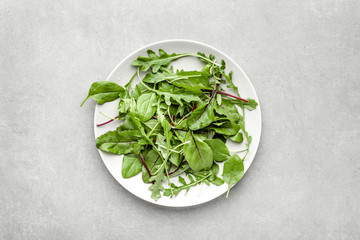 Wall Mural - Fresh salad with green leaves on plate, top view