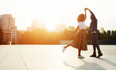 Wall Mural - Love is in the air. Romantic couple dancing at sunset