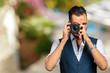 © fotofabrika - east asian handsome man taking a shot with camera