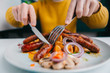 © MiniDiem - Close up of man eating sausages