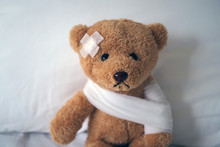 Sad Bear Doll Lying Sick In Bed With The Wound On The Head And Bandage